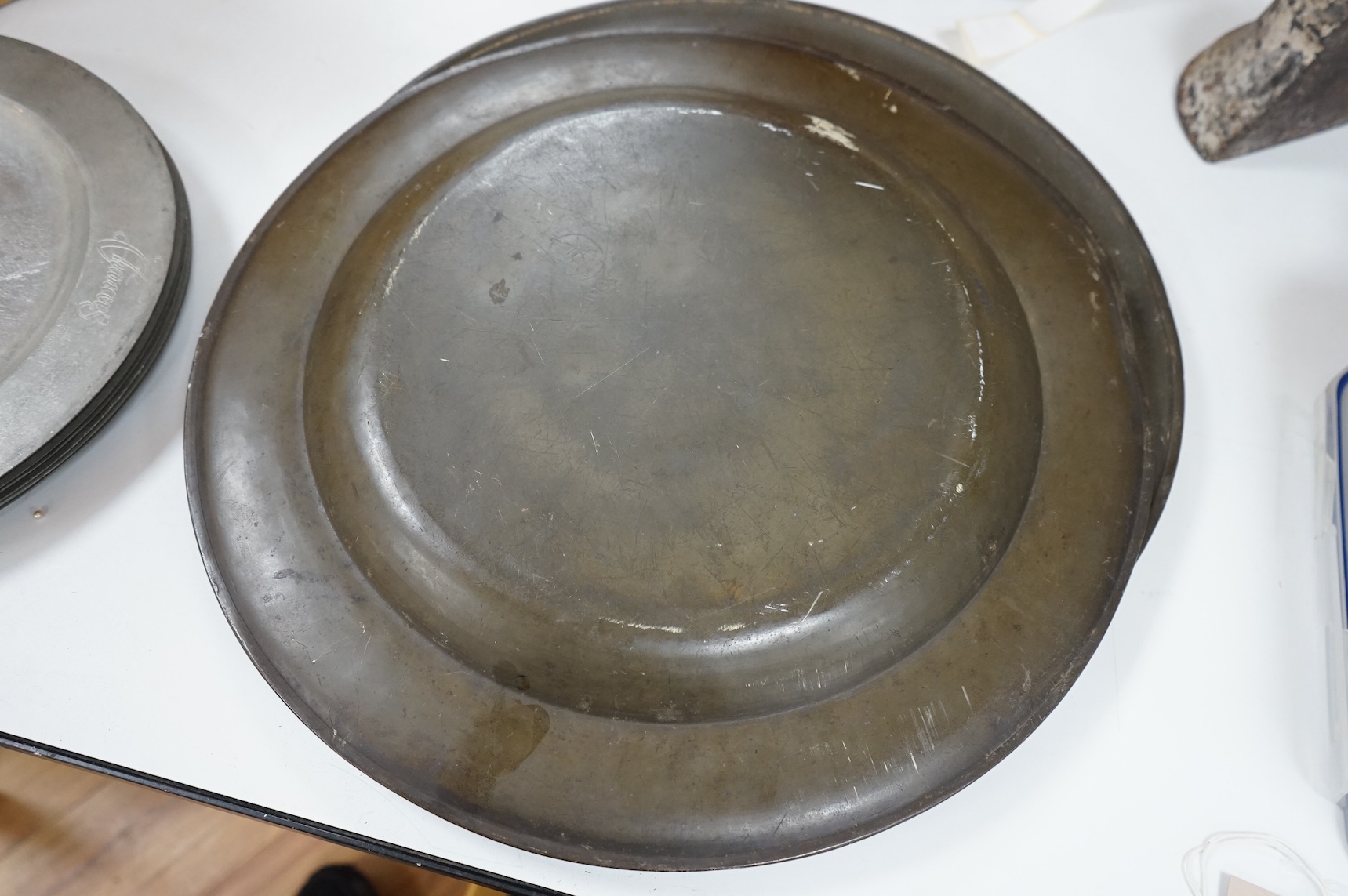 Two 19th century pewter chargers and a set of six pewter plates, largest 42cm in diameter
